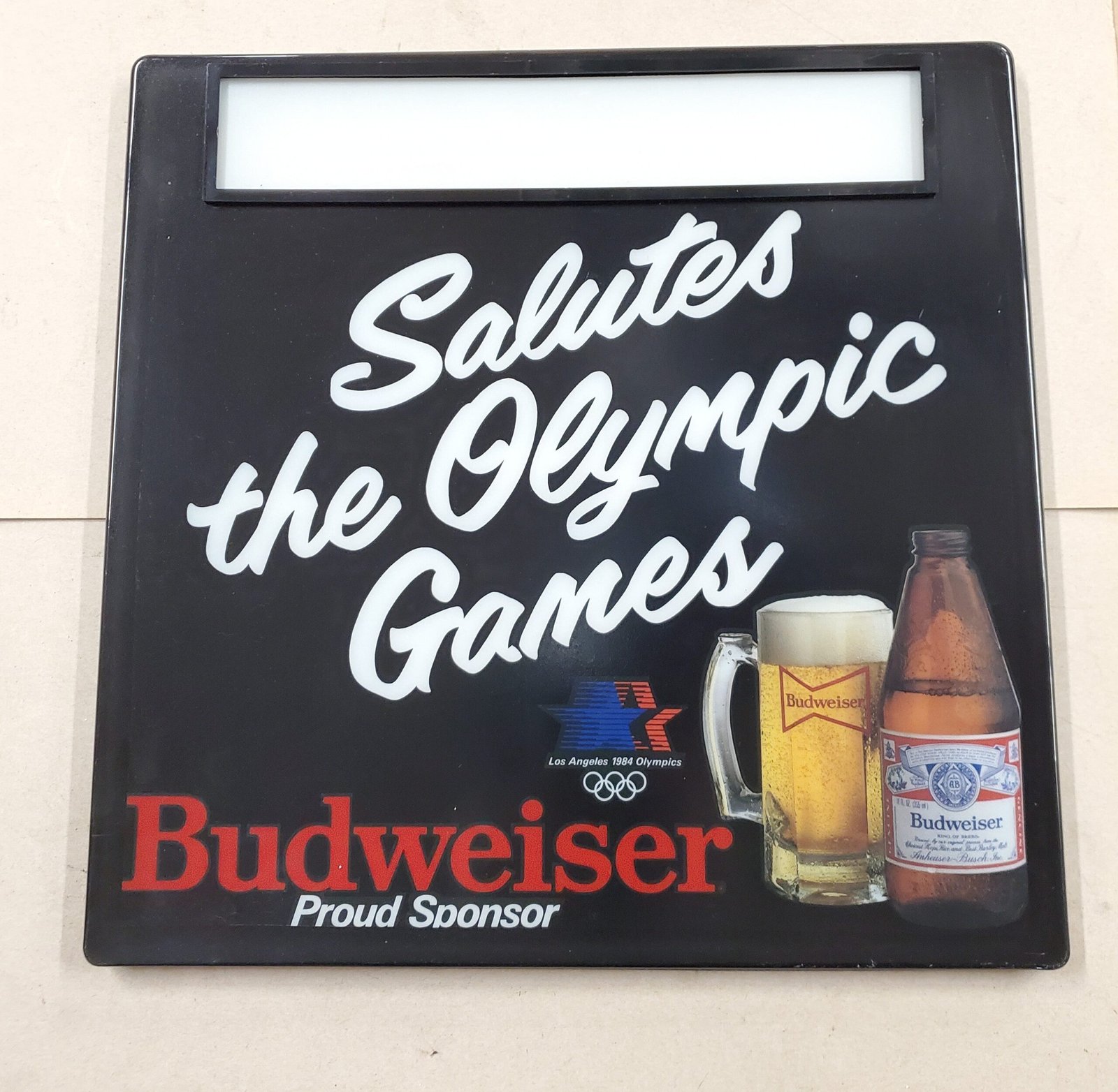20260313_104047-scaled-1.jpg Plastic Bud Light Beer Sign 1984 Olympic Games Advertisement Breweriana 18" x 18