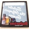 20260313_104209-scaled-1.jpg Plastic Bud Light Beer Sign 1984 Olympic Games Advertisement Breweriana 18" x 18