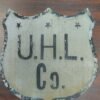 83096ea8-25e6-4fba-a725-0c9ad1a9087c-scaled-1.jpg Antique UHL Co. Metal Shield Sign Industrial Advertising Highway Marker Vtg tin!