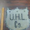 96862557-ca40-4a84-aad4-2de04e18e783-scaled-1.jpg Antique UHL Co. Metal Shield Sign Industrial Advertising Highway Marker Vtg tin!