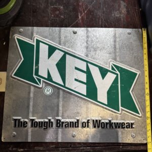 vintage metal advertising sign for KEY Apparel "The Tough Brand of Workwear"